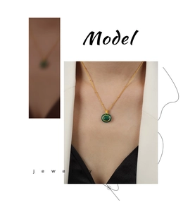 Detail showing gold chain with small bead accents and square malachite stone pendant