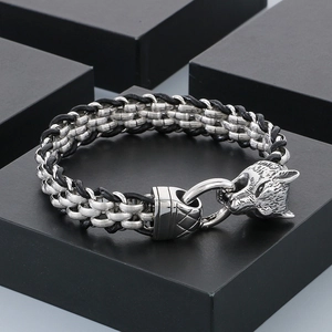 Detailed view of braided stainless steel Viking wolf head bracelet with leather accents