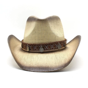 Detail of straw cowboy hat with ethnic embroidered band and silver metal disc pendants