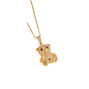 Luxury gold teddy bear pendant necklace with sparkling crystals on white background