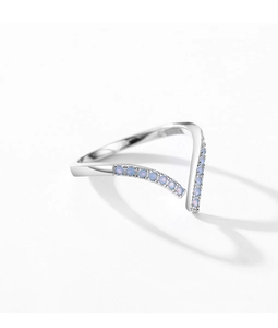 Macro detail of V-shaped silver ring featuring small round light blue opal stones