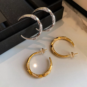 Luxurious C-shaped twisted hoop earrings with micro-paved zircons in gold and silver