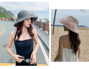 Detail of elegant summer sun hat with large brim and layered floral organza decorations
