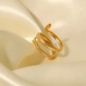 Macro detail of the golden snake ring showing intricate scale textures on silk