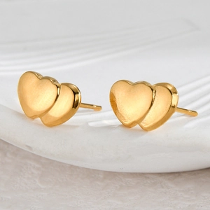 Elegant gold heart-shaped stud earrings featuring a minimalist layered double heart design