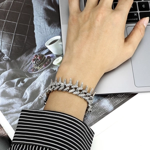 Silver thorn bracelet with diamonds worn on wrist in a daily lifestyle office setting