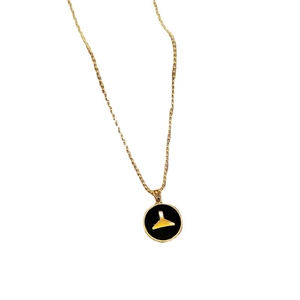 Minimalist gold titanium steel necklace with a round black and gold pendant on white background