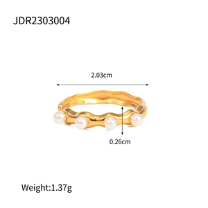 Detail view of wave-textured gold ring featuring four white pearls with size measurements