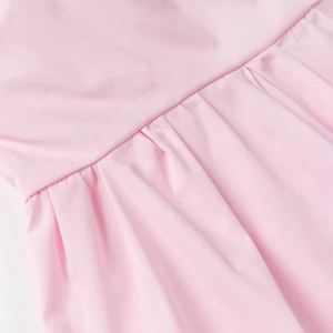 Detailed macro view of pink strapless top fabric showing soft pleated texture and stitching