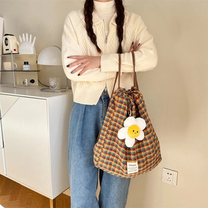 Multicolor plaid drawstring backpack tote with plush sunflower charm and large capacity