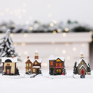 Set of four colorful Christmas village miniature buildings with realistic snow effects