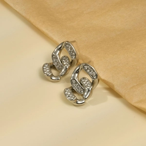 Macro detail of silver geometric chain link earrings featuring micro-paved white zircons