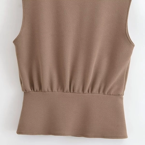Detailed macro view of the brown textured fabric and gathered waistline of the fashion set