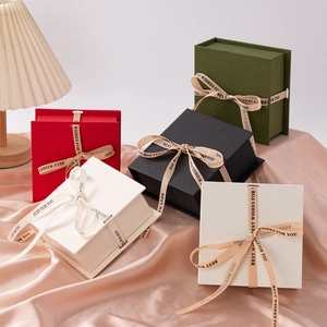 Elegant multi-color specialty paper jewelry gift boxes with satin ribbons on pink silk