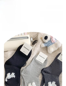 Detailed view of combed cotton crew socks featuring cute cat embroidery and ruffle trim