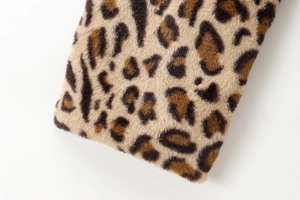 Macro shot of faux leopard fur texture with realistic brown and black animal print