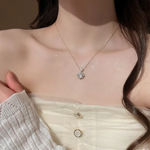 Detailed view of 14k gold plated necklace with a sparkling cubic zirconia flower pendant