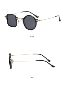 Detail of round and square asymmetric sunglasses with black and gold metal frames