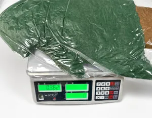 Weight measurement of the green Christmas tree plush cushion in plastic packaging