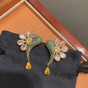 Elegant gold flower wing earrings with purple zircons and yellow pear-shaped pendants