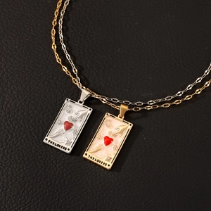 Detailed macro view of The Lovers tarot card necklace with red heart and moon relief