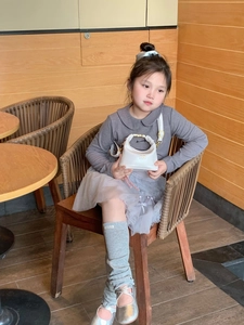 Girl carrying white PU leather mini handbag in a cafe scene with shoulder strap