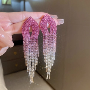 Close-up of pink gradient rhinestone tassel earrings worn by a model in elegant style