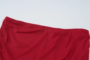 Detail of red mesh fabric showing premium knit texture and stitching on double-layer dress