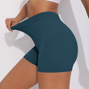 Close-up of high-waisted dark blue yoga shorts showing elastic stretch fabric detail