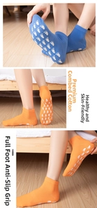 Detail of non-slip yoga socks with silicone grips on wooden floor for adults and kids