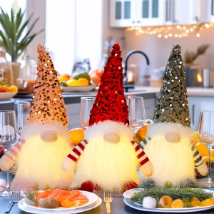 Three sequined Christmas gnomes with glowing LED beards in a cozy kitchen setting