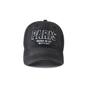 Detail of white PARIS embroidery on high-quality black washed cotton baseball cap
