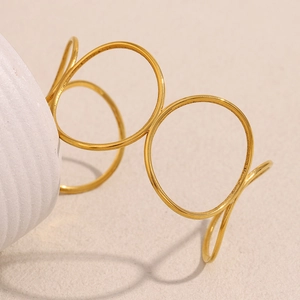 Detail shot of a minimalist 18K gold plated stainless steel geometric hollow bangle