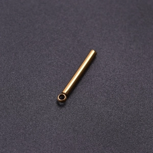 Macro shot of polished gold 304 stainless steel cylindrical bar pendant for DIY jewelry