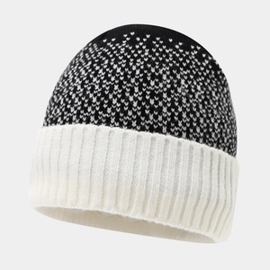 Detail of black and white jacquard knit beanie with thick ribbed cuff and geometric texture