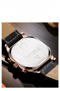 Detailed close-up of the stainless steel back of a rose gold men's watch with leather strap