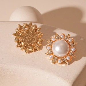 Macro view of gold baroque sunflower stud earrings with pearls and crystal rhinestones