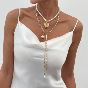 Boho layered necklace set with pearls, shell pendant, and golden cross for women