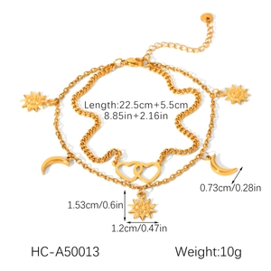 Detailed view of dual-layer gold anklet with sun, moon, and heart pendants and sizing info