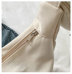Detail of smooth metal zipper on nylon crossbody bag with durable twill fabric texture