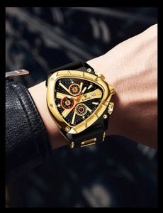 Close-up of a men's triangular gold watch with black silicone strap on a leather jacket
