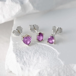 Detailed macro view of S925 sterling silver studs with purple heart and teardrop gemstones