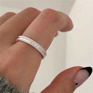 925 silver ring with beaded edges and white zircons shown on a finger