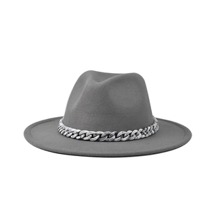Detail shot of a gray fedora hat with a stylish thick grey and white chain accessory