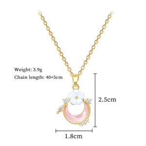 Detail view of gold floral moon pendant with dimensions 2.5x1.8cm and 3.9g weight