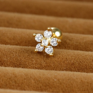 Macro shot of gold flower earring with clear cubic zirconia in a velvet box