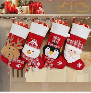 Set of 4 festive knitted Christmas stockings with reindeer and snowman on a fireplace