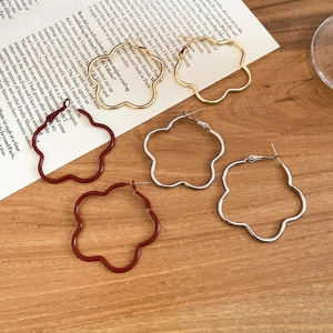 Three pairs of retro large hollow flower-shaped metal hoop earrings in gold silver and red