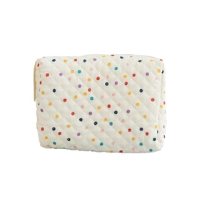 Quilted white cotton cosmetic bag with colorful polka dots for travel storage
