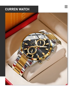 Close-up of business chronograph watch with golden accents and tachymeter bezel